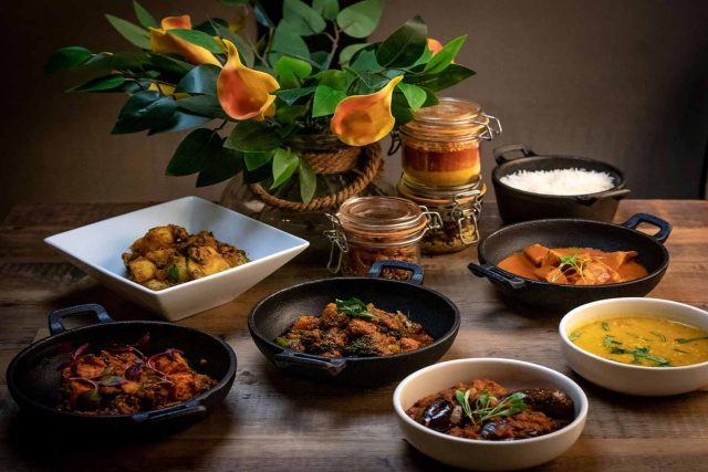 A luxurious spread of contemporary Indian dishes including rich curries, dal, chicken tikka, and fragrant rice, prepared for a Mother's Day celebration at our Petts Wood restaurant.