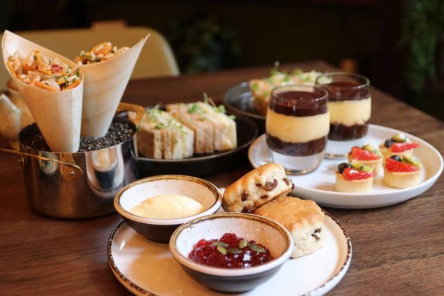 A luxurious Indian-inspired afternoon tea spread featuring traditional scones, contemporary chaat, and delicate pastries, served at our Petts Wood restaurant.