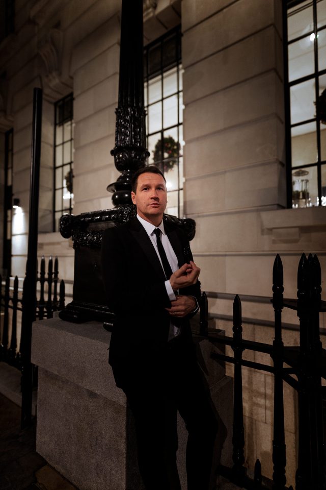 An elegantly dressed guest standing outside before an exclusive dining experience at Indian Essence in Petts Wood.